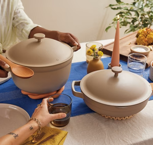 Table set for a meal with beige pots and flowers